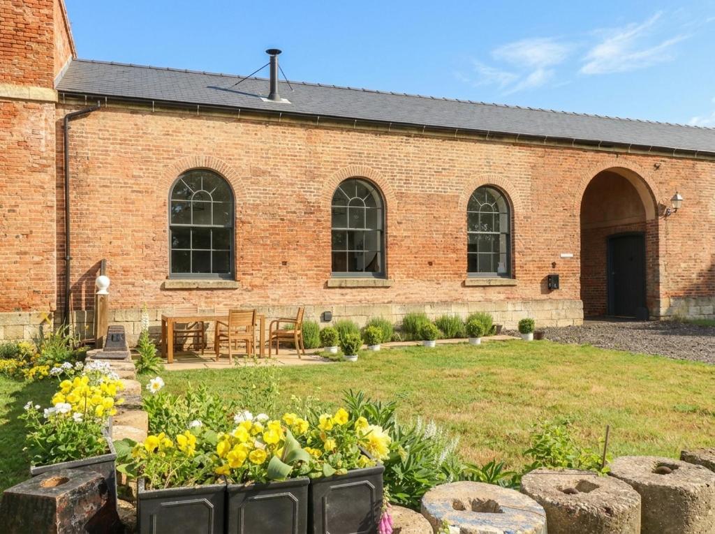 a brick building with a garden in front of it at West Stable in Retford