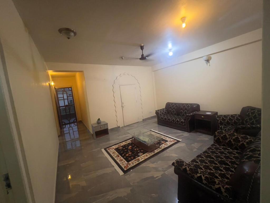 a living room with two couches and a table at Namaste Apartment in Pokhara