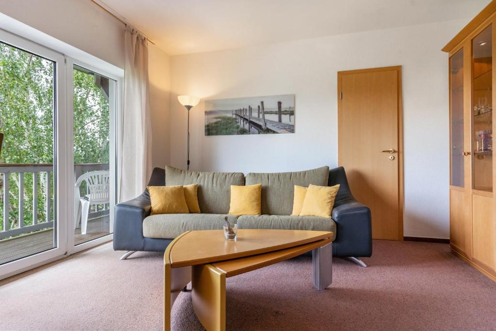a living room with a couch and a table at Sonnengelb - Fulgenhaus in Klein Bollhagen