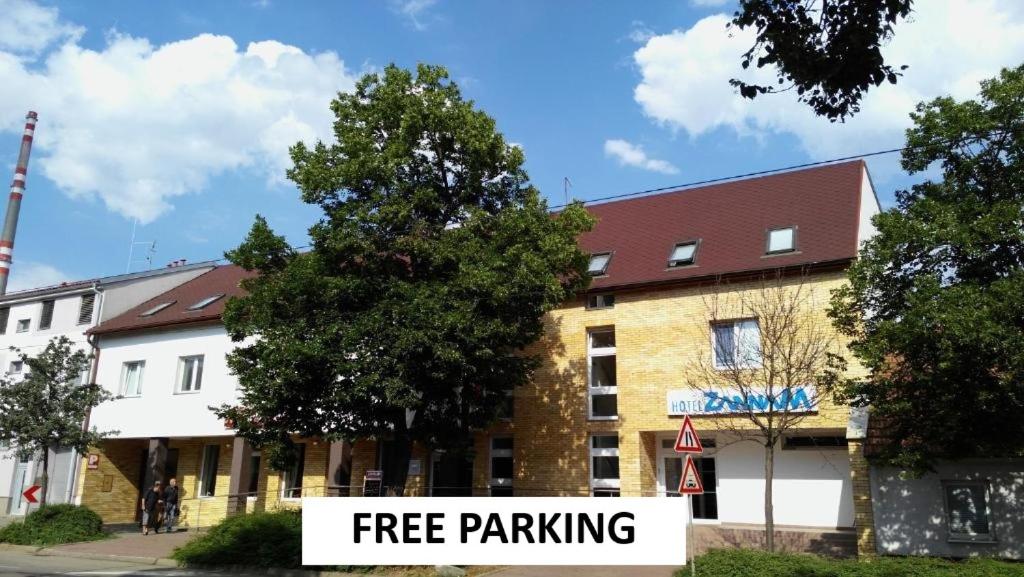 a free parking sign in front of a building at Hotel Zannam in Brno