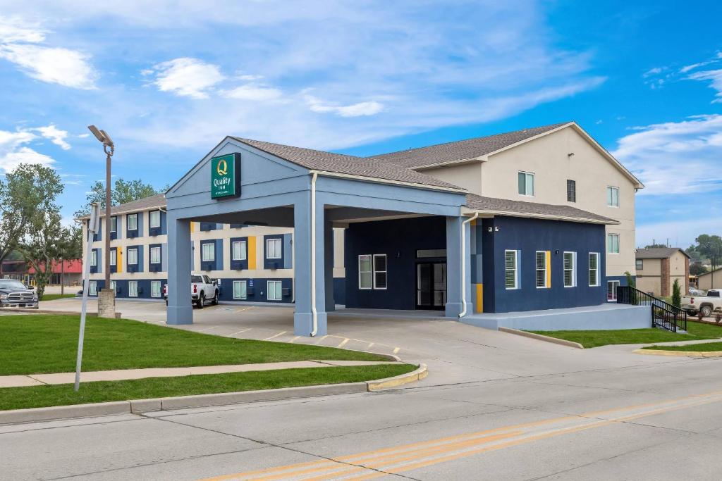 a building with a parking garage in front of it at Quality Inn Ponca City in Ponca City