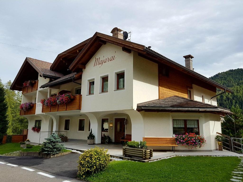 a building with a sign on the side of it at Residence Majarai in Colfosco