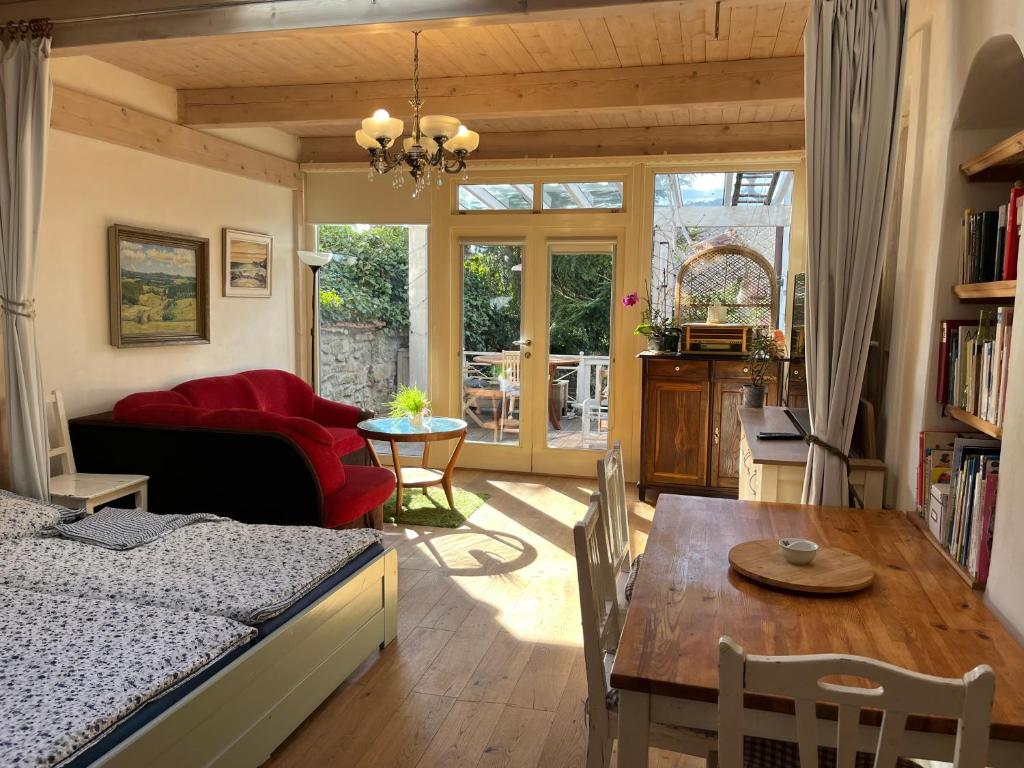 a bedroom with a bed and a table and a dining room at Staré časy in Chotěboř