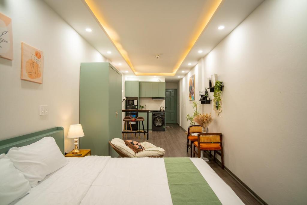 a bedroom with a bed and a living room at Hanoi Olive Boutique in Hanoi