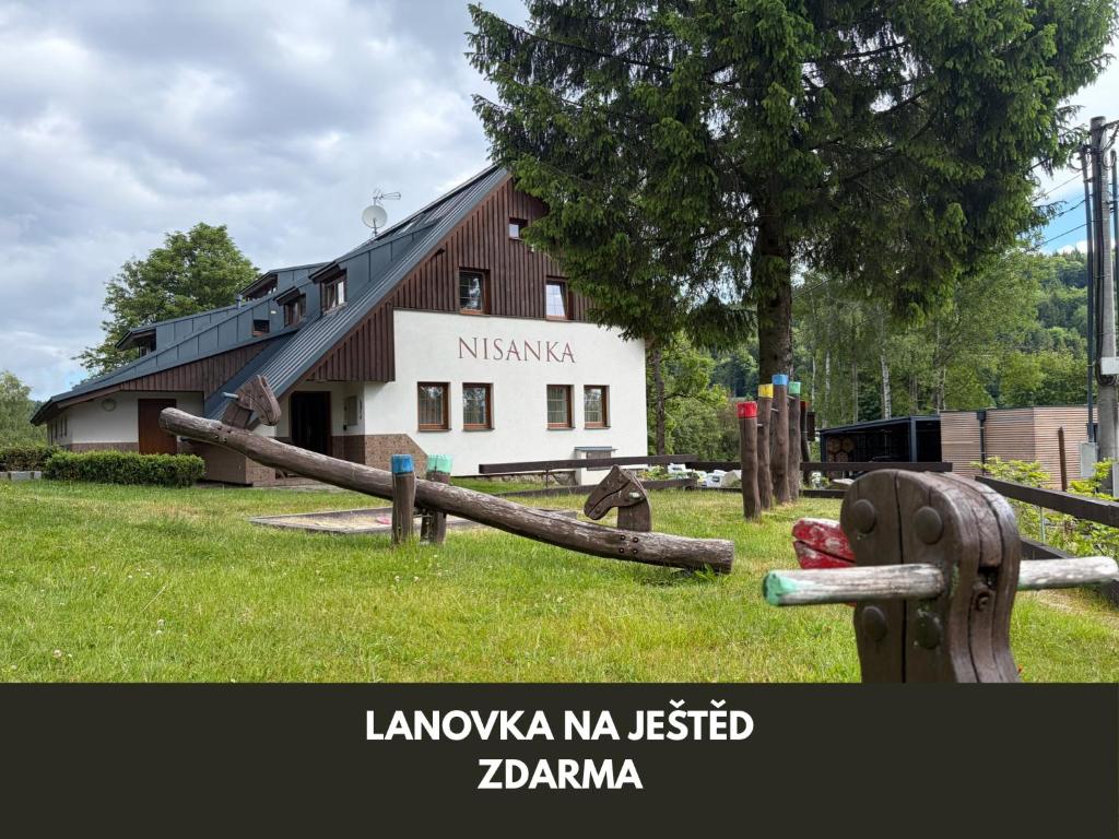 a building with a wooden fence in front of it at Chata Nisanka in Bedřichov