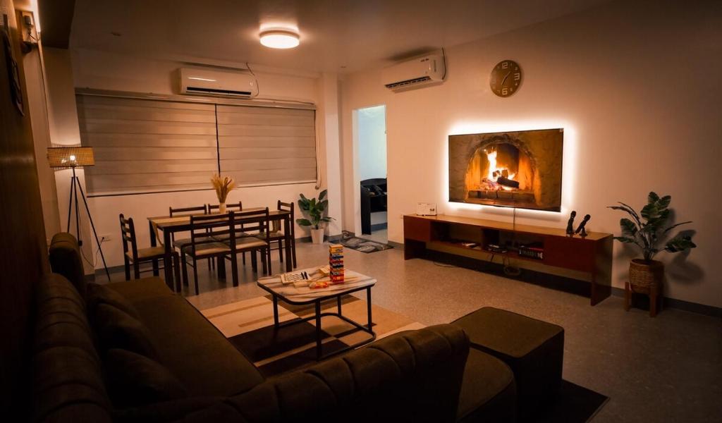 a living room with a couch and a fireplace at Balay Salazar in Malolos