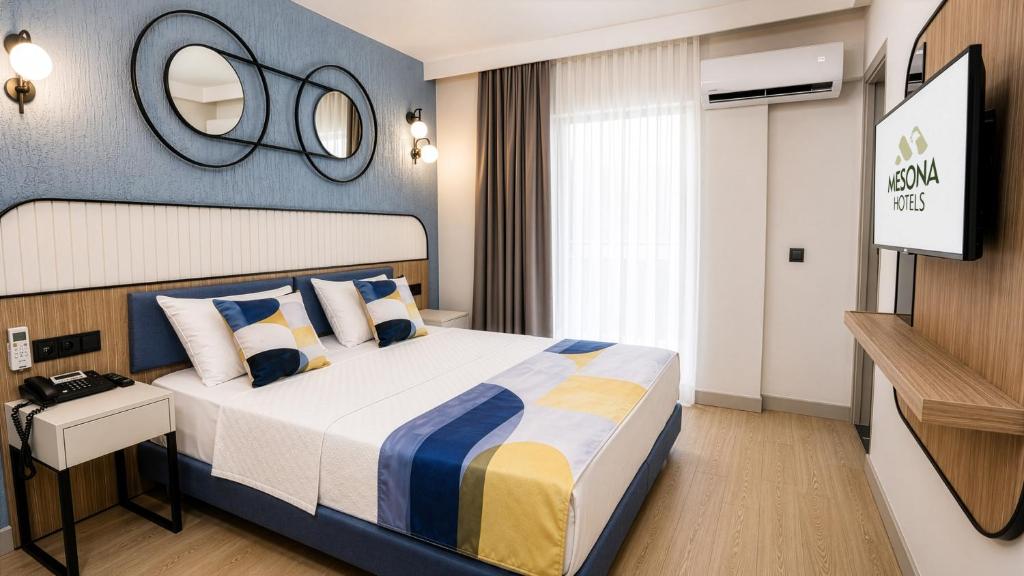 a bedroom with a large bed and a mirror at Mesona Hotels Blue Hill in Antalya