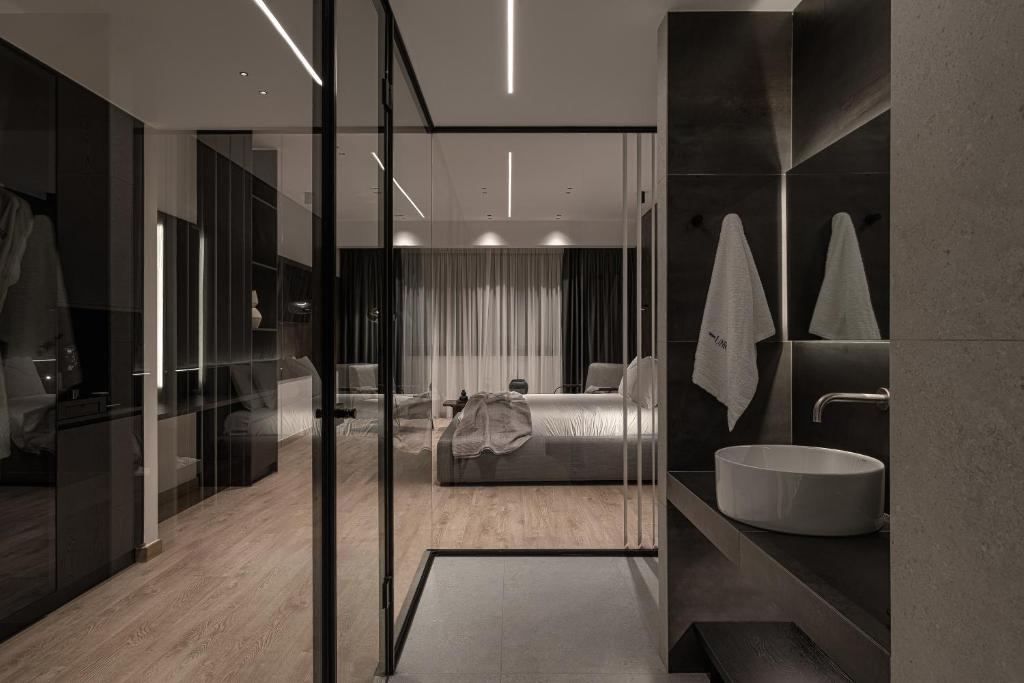 a bathroom with a tub and a bed in a room at Union43 Ioannina in Ioannina