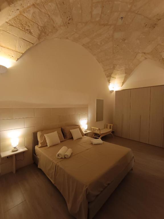 a bedroom with a large bed with two towels on it at Il rifugio barocco in Lecce
