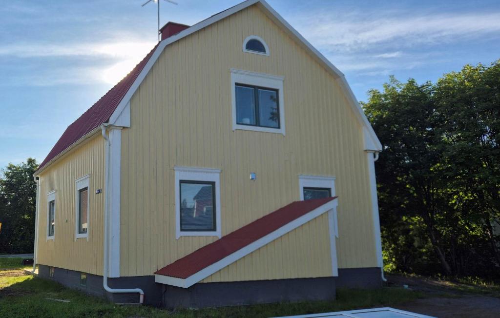 a yellow house with a red roof at The Yellow House in Boden