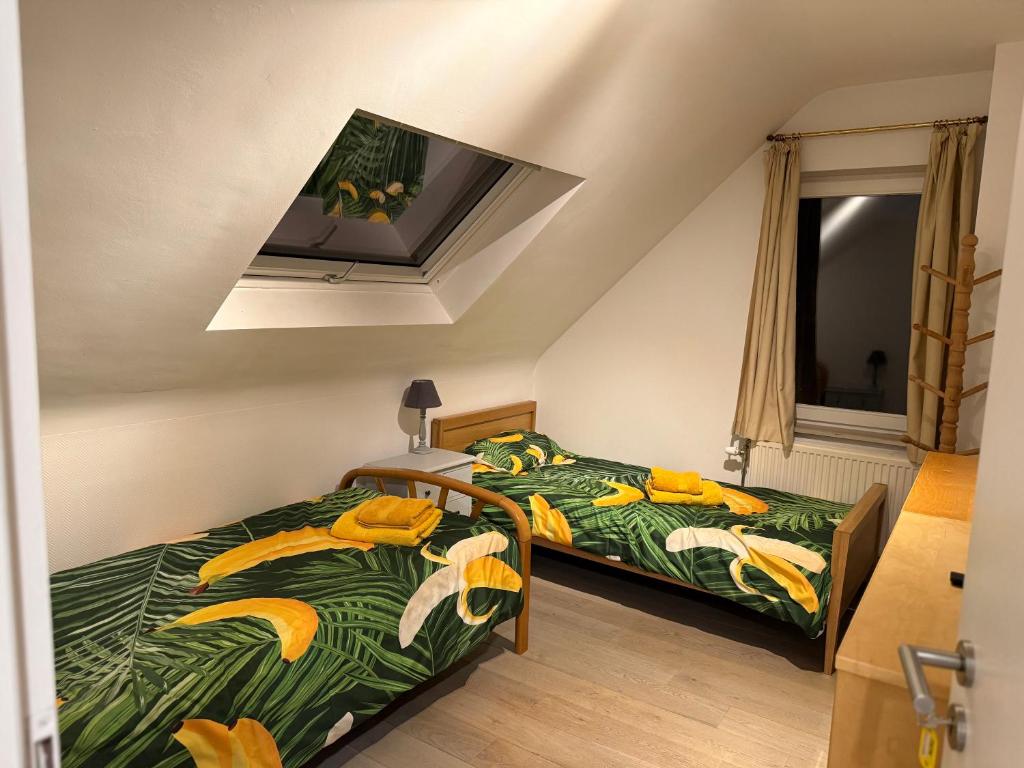 a bedroom with two beds with bananas on them at Martinique in Chaumont-Gistoux