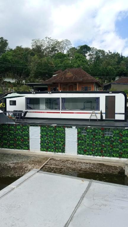 a train is parked on the tracks next to flowers at ARA Caravan Villa in Bedugul