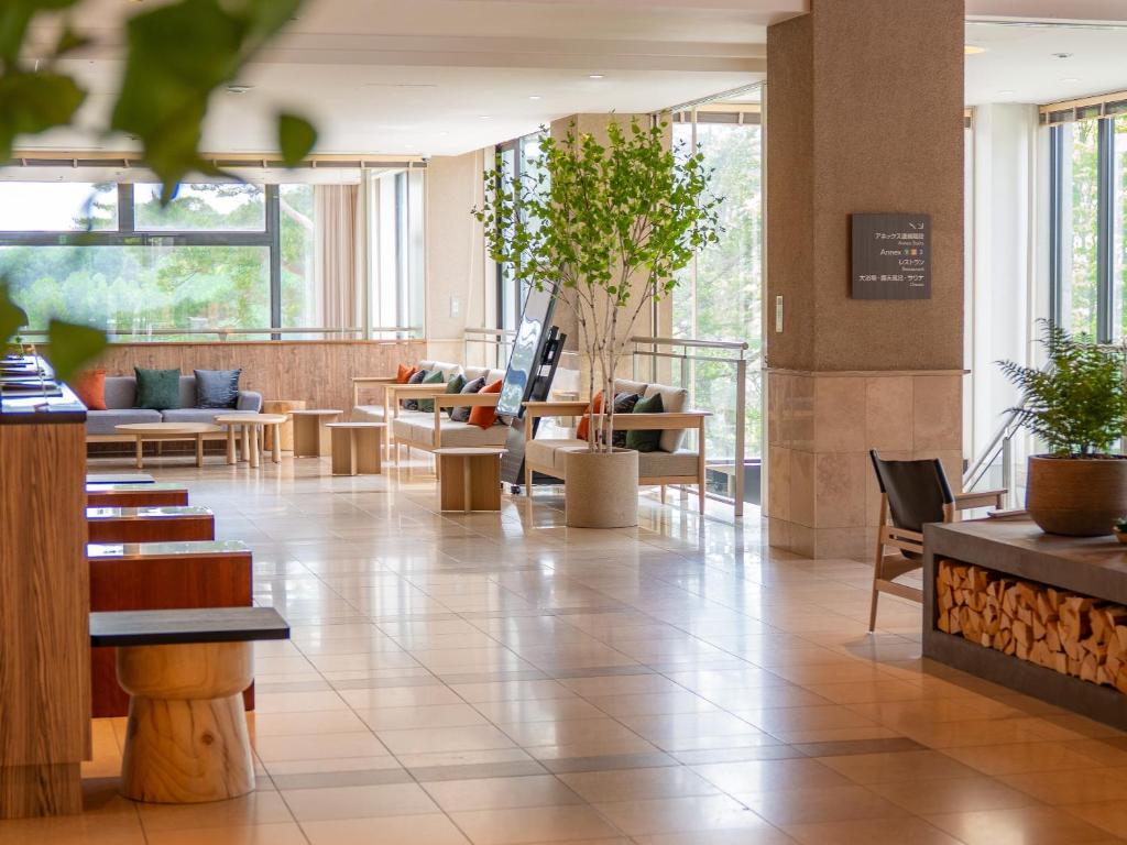 a lobby with chairs and tables in a building at Tateshina Lake Resort in Tateshina