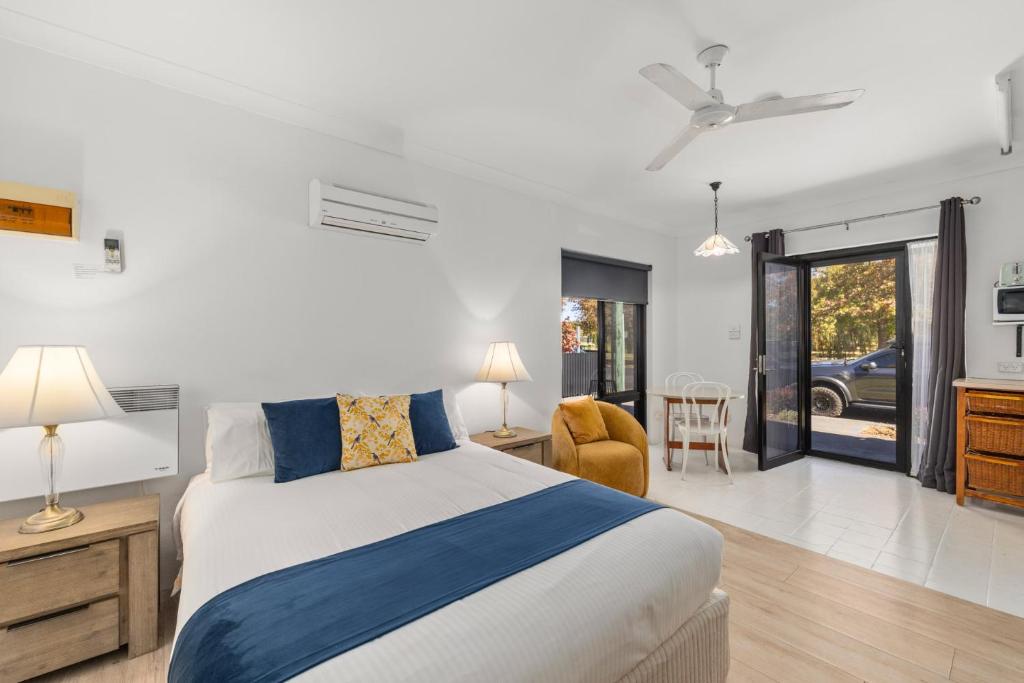 a bedroom with a bed and a living room at Charlesworth On The Park in Glen Innes