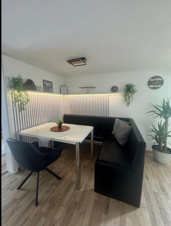 a living room with a couch and a table at Ferienwohnung bei Karl in Schmallenberg
