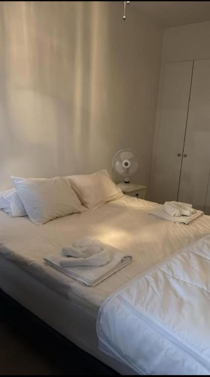 a white bed with two towels on top of it at Marina in Tampere