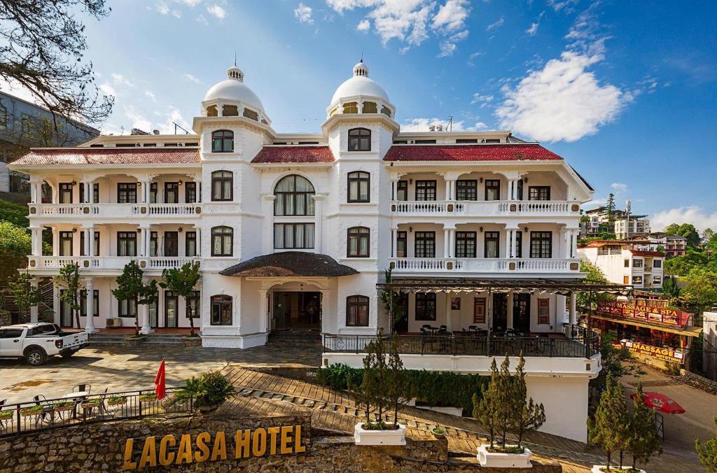 a large white building with a lot of windows at Lacasa Sapa Hotel in Sapa