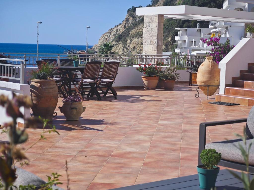 a patio with chairs and tables on a balcony at Adriatic Apartment in Ulcinj