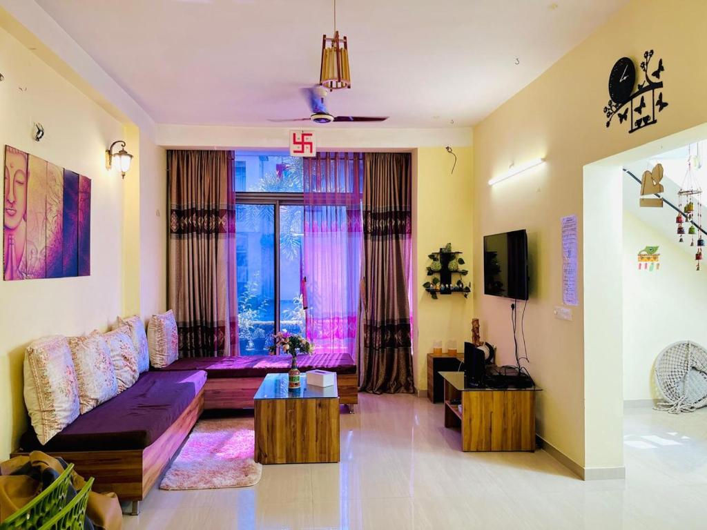 a living room with a couch and a window at Paradise Villa in Siliguri