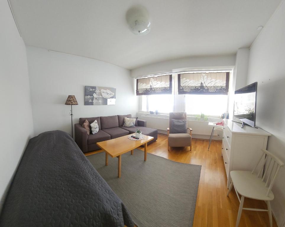 a room with a bed and a couch and a table at Apartment Asemakatu 20 in Kuopio