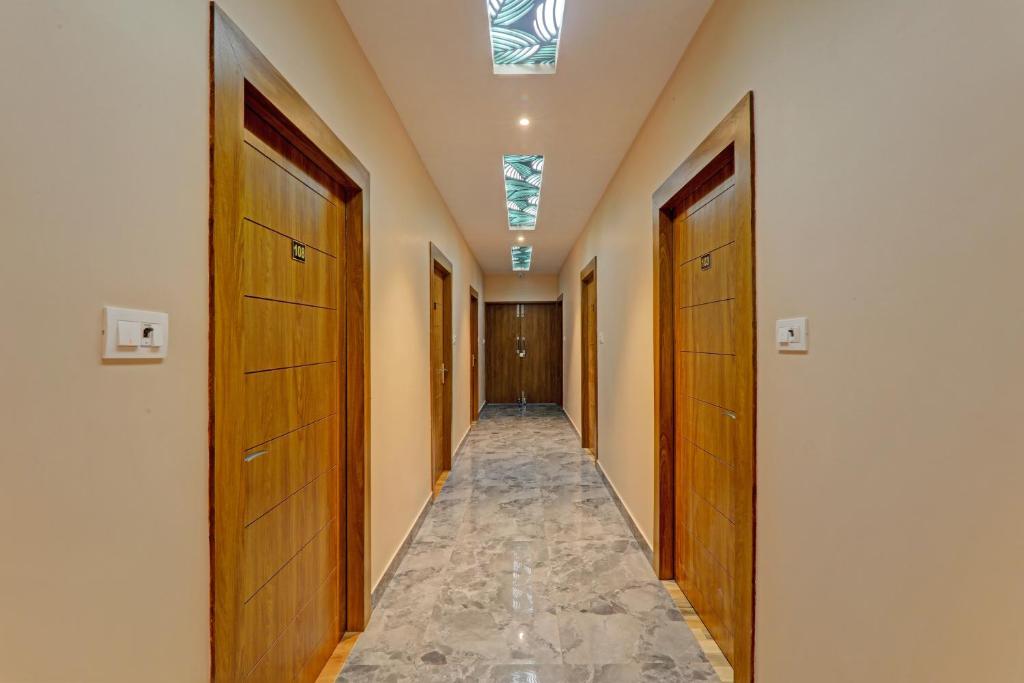 a hallway with wooden doors and a walkway at Hotel O Royal Regency Palace in Gorakhpur