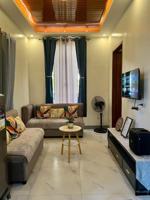a living room with a couch and a table at Baldonado Transient Homestay in San Isidro