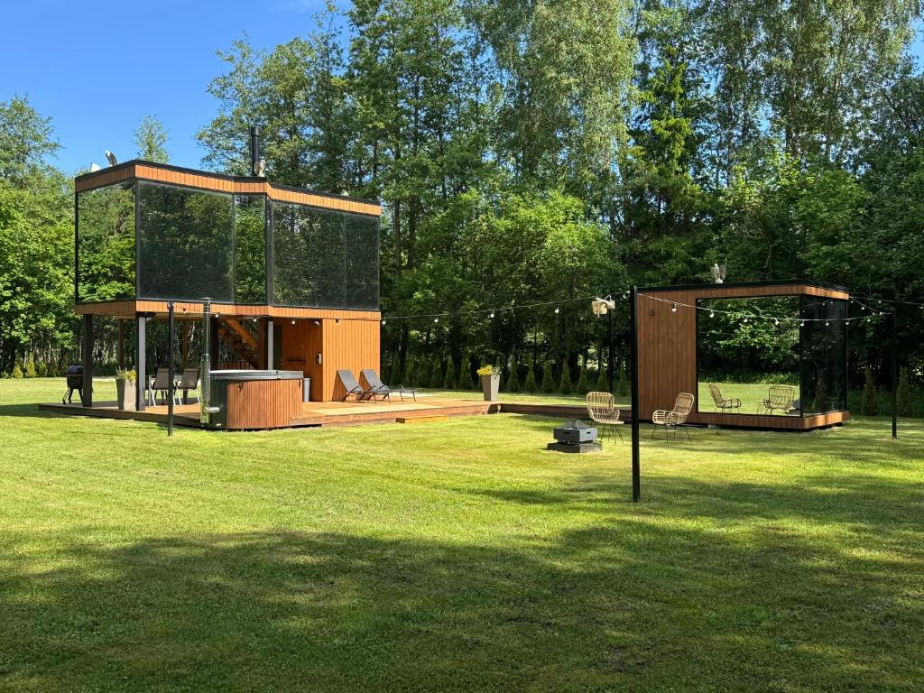 a building in a field in a park at Forest Reflection Minivilla in Partsi