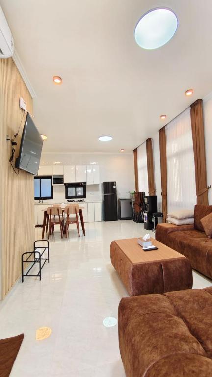 a large living room with a couch and a table at Villa Dalia Puncak EE11-24 in Cikujang