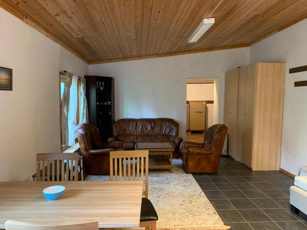 a living room with leather furniture and a table at Very Attractive Location in Täby