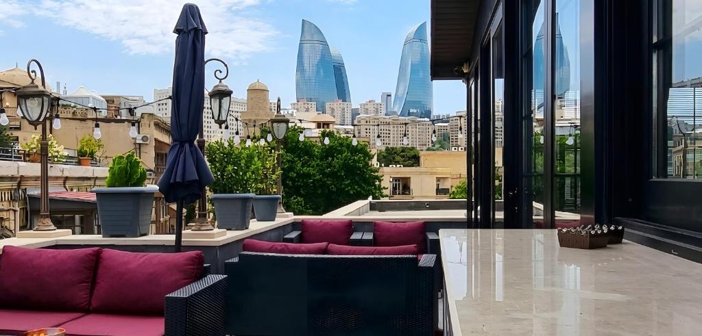 a balcony with a view of a city skyline at West inn Luxury Baku in Baku