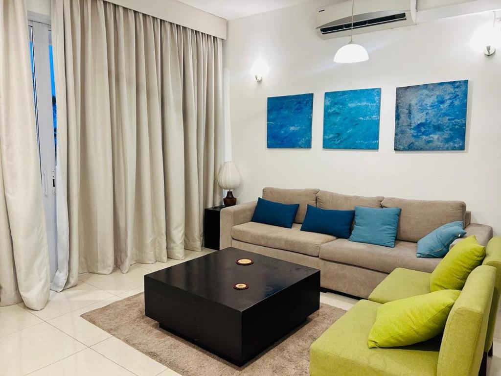 a living room with a couch and a coffee table at apartmentleeza in Uswetakeiyawa