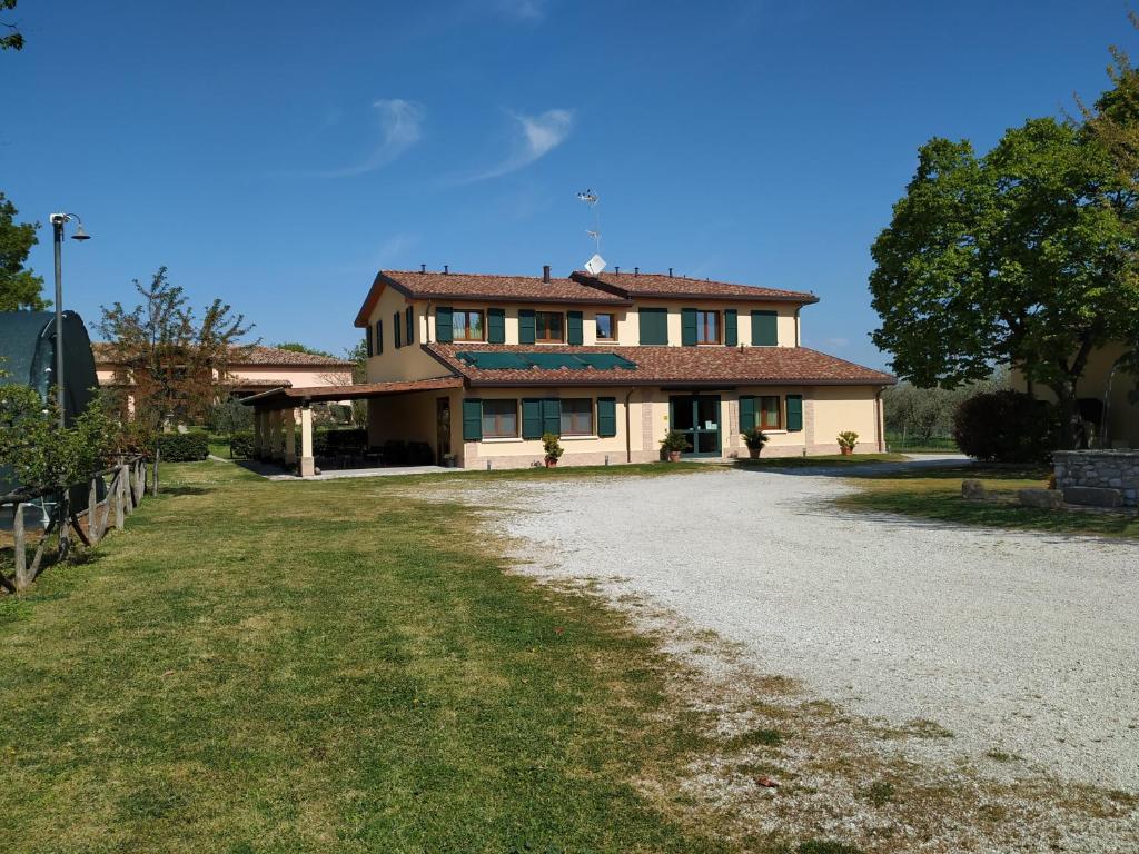 a large house with a driveway in front of it at La Valle in Villa Verucchio