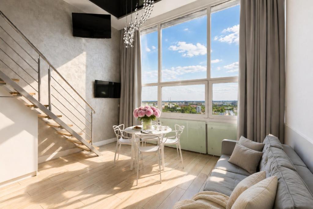 a living room with a couch and a table at Panorama- the View of Gdańsk by Elite Apartments in Gdańsk