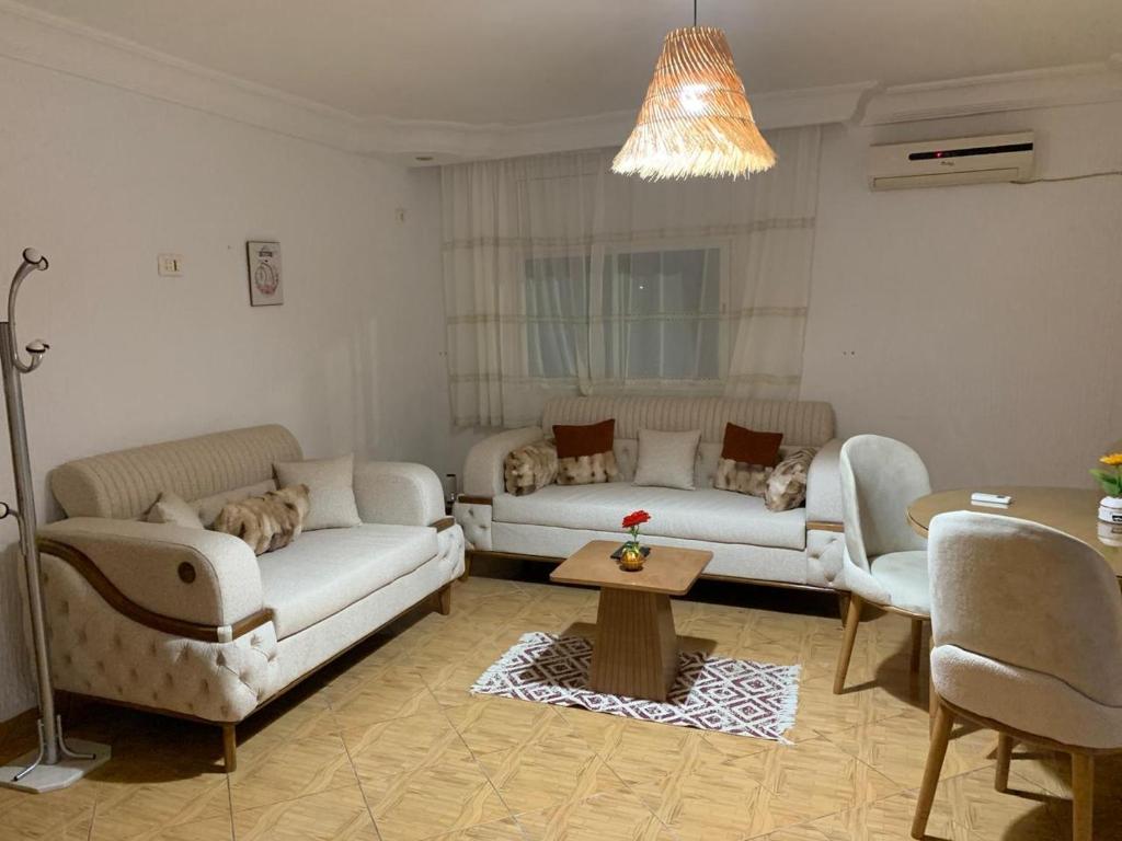 a living room with two couches and a table at honey moon zeinbe 4 in Hammamet