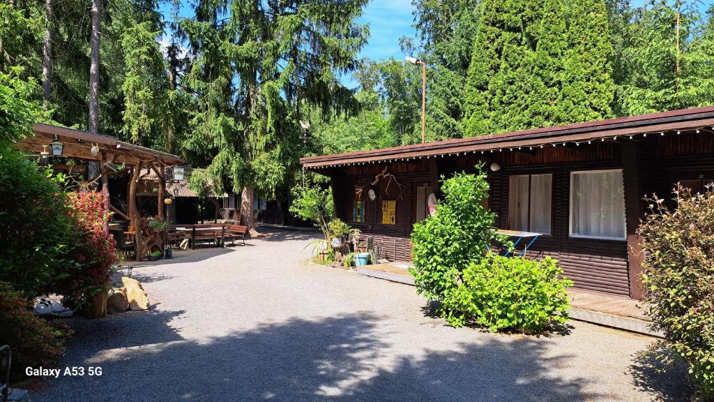 a log cabin with a porch and a patio at Ferienzentrum Briesensee in Neu Zauche