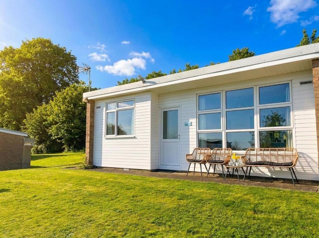 a house with a table and chairs in a yard at Serene Sea Valley in Bucks Mills