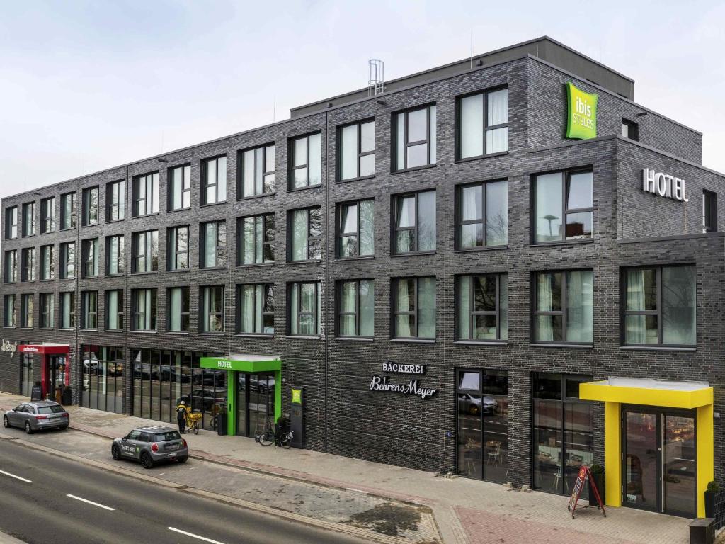 a large brick building on the side of a street at ibis Styles Vechta in Vechta