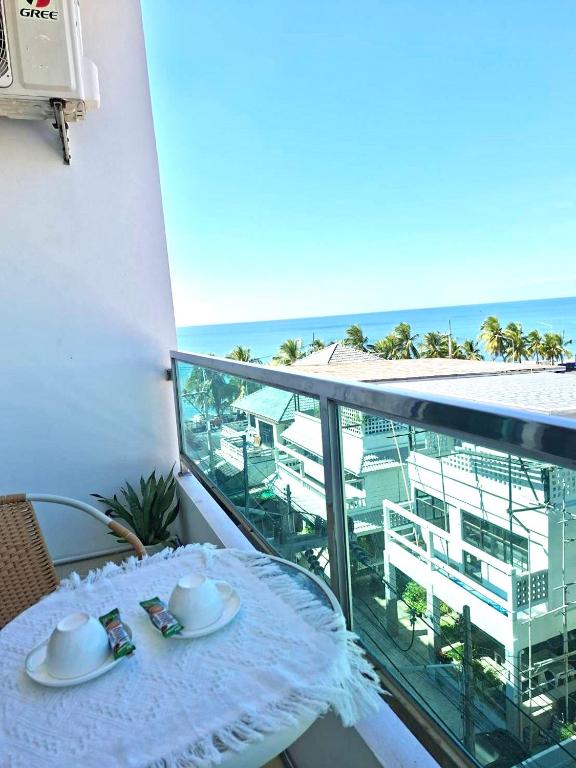 a table on a balcony with a view of the ocean at Exclusive Sea View in Chon Buri
