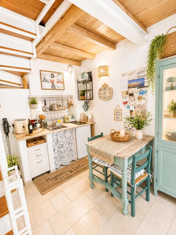 a kitchen with a table and a kitchen with a stove at TorreParadiso Holidays in Polignano a Mare