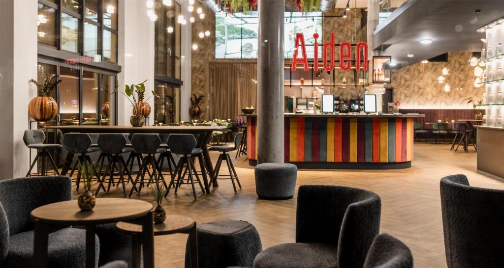 a restaurant with chairs and tables and a bar at Aiden by Best Western Velbert in Velbert