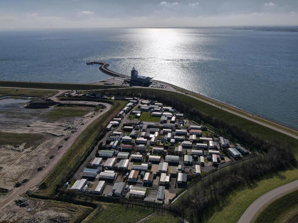 an aerial view of a large group of houses by the water at Zeester 91 in Scherpenisse