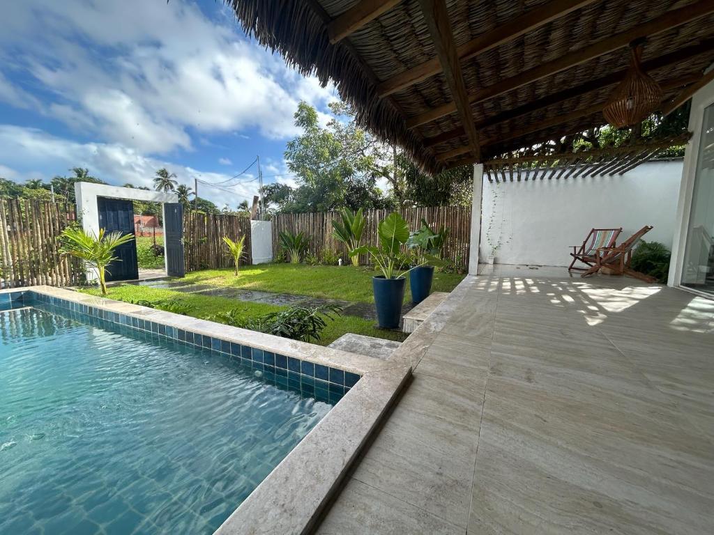 a swimming pool in a backyard with a house at Casa Rio - Santo Amaro in Santo Amaro