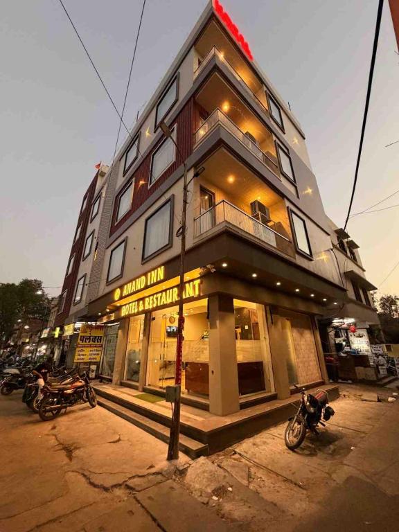 a tall building with motorcycles parked in front of it at Hotel Anand Inn in Kota