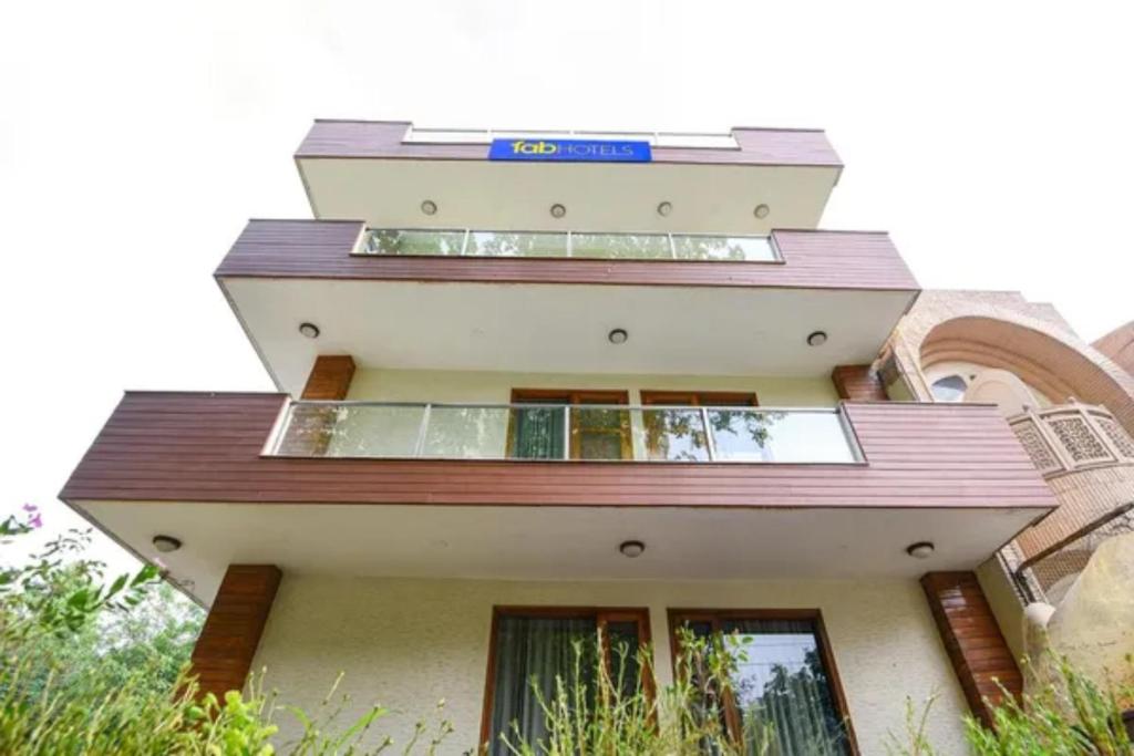 a building with a sign on the top of it at FabHotel The Lalit Vibes - Nr DLF Phase 2 & MG Road Metro in Gurgaon