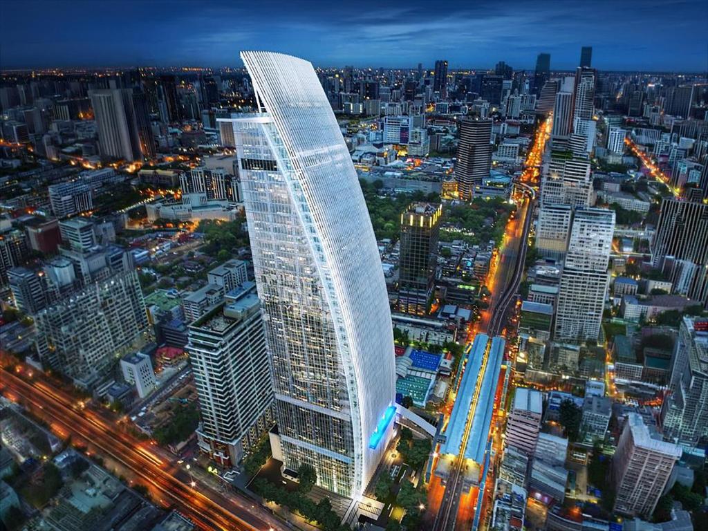 a rendering of a tall building in a city at night at Ibis Bangkok Siam Ratchathewi in Bangkok