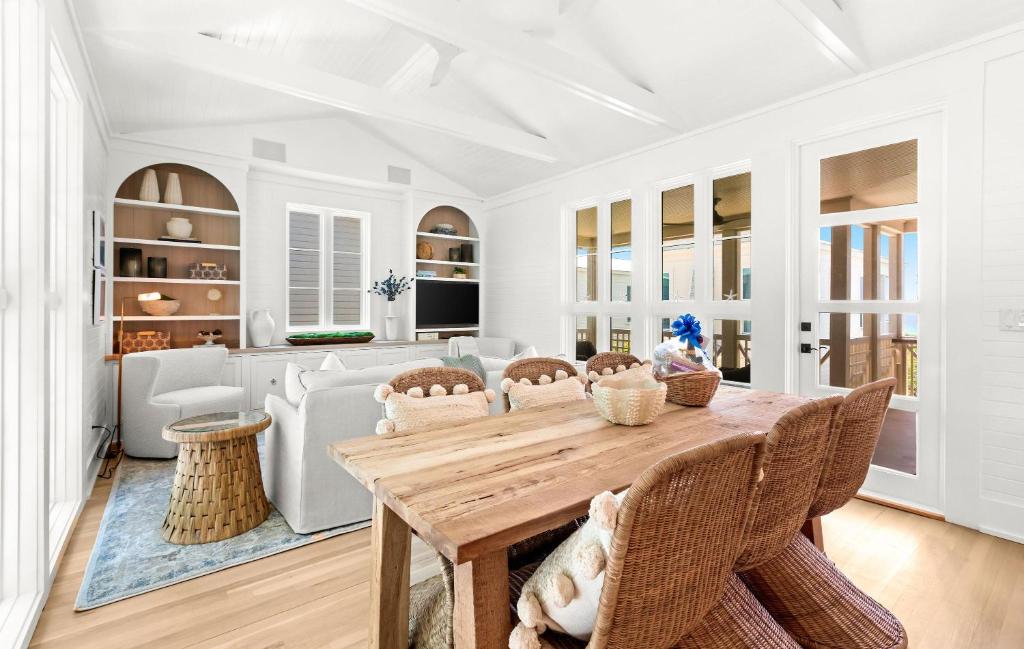 a kitchen and living room with a wooden table and chairs at Luv U Honey in Santa Rosa Beach