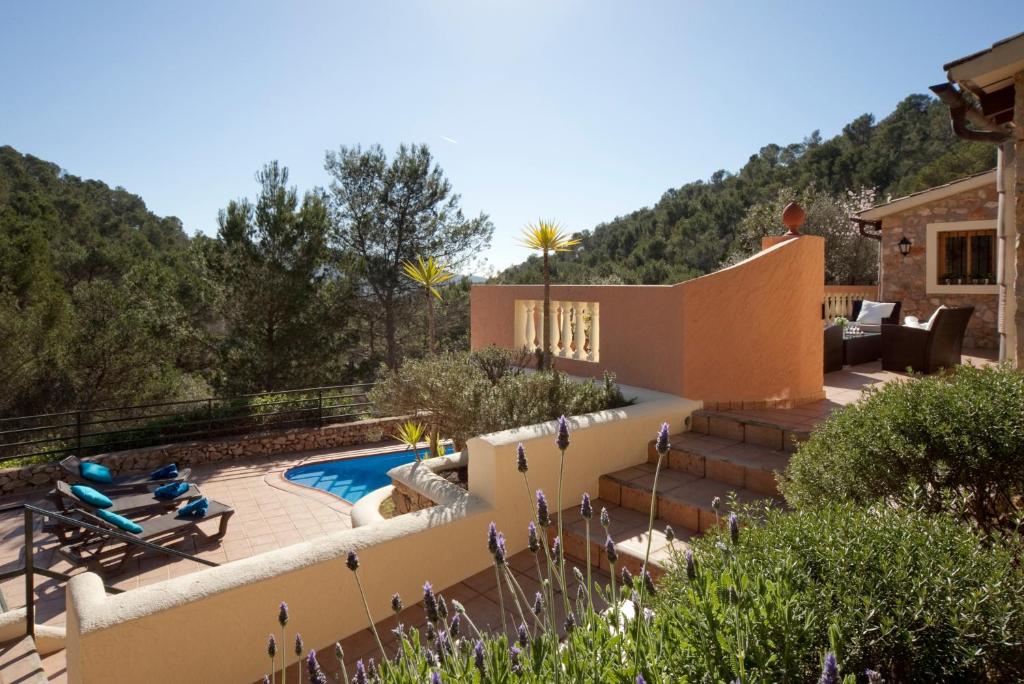 a backyard with a swimming pool and a house at Villa Magdalena Calvia in Calvià