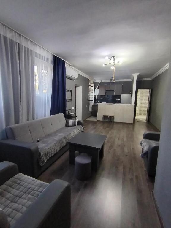 a living room with a couch and a table at Guest House in Garni