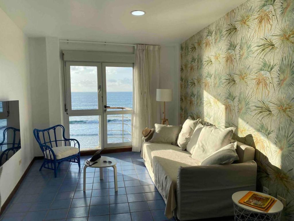 a living room with a couch and a view of the ocean at Numancia 1 - 2A in Las Palmas de Gran Canaria