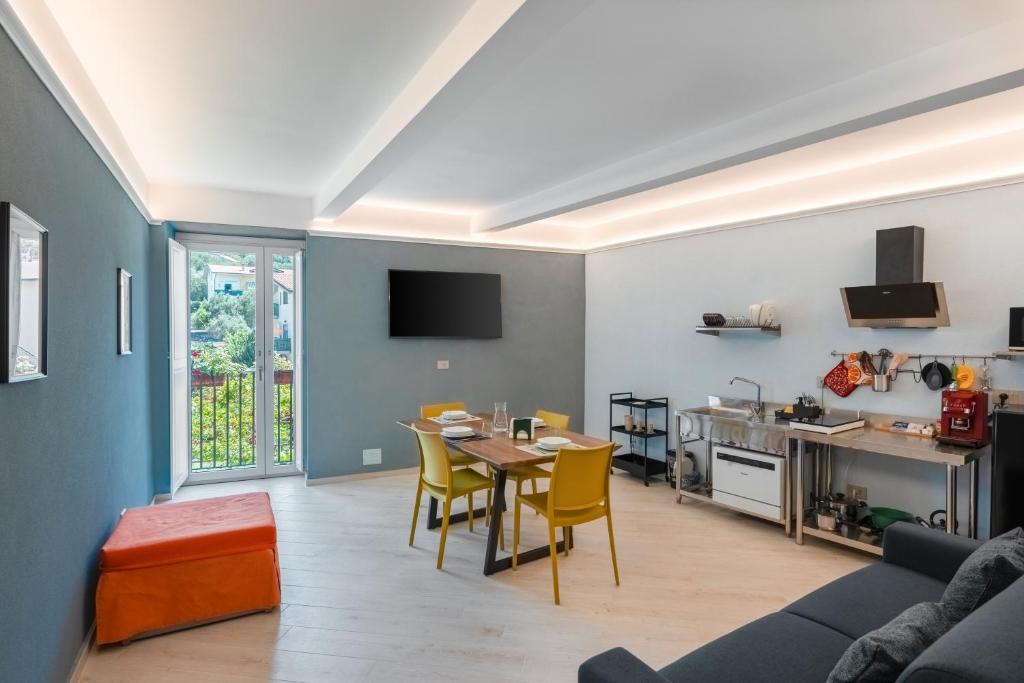 a living room with a table and a kitchen at Parmenide Family Apartment in Ascea